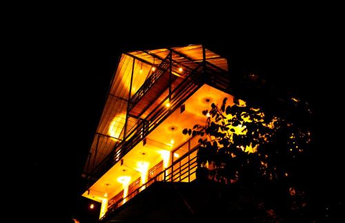 a tall building with lights on it at night at Mountain Breeze Villa & Ayurveda Spa in Ella