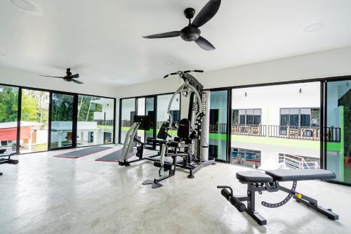 a gym with treadmills and cardio equipment in a house at Samui Hills Resort in Amphoe Koh Samui