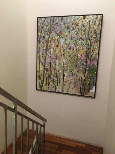 a painting of a tree on a wall at Marina Oriental Hotel in Butterworth