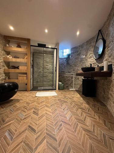 a room with a large glass door and a stone wall at Chambre privée avec salle de bain tourelle in Domagné