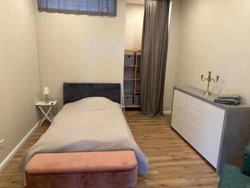a small bedroom with a bed and a dresser at Urban Comfort Apartment in Rheinbach