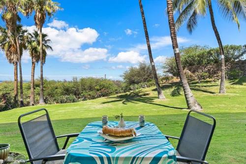 a table with a cake on top of it with palm trees at Keawakapu 208 · KKP 208 Renovated Condo w AC Near Beach Shops in Wailea