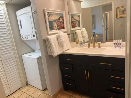 a bathroom with a sink and a large mirror at Eldorado K203 · EL K203 2BD Condo w AC Pool Beach Cabana in Kahana