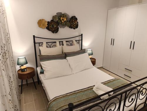 Un dormitorio con una cama grande con almohadas blancas. en Belvedere Luxury Suite, en Tríkala