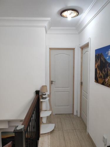 a hallway with white walls and a white door at casa cairasco in Las Lagunas
