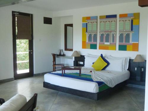 a bedroom with a large bed in a room at Buckingham Place in Tangalle