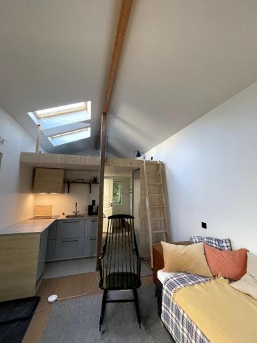 a room with a couch and a kitchen with a loft at Guesthouse at Roland's in Uppsala