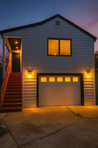a house with a garage door and a staircase at The studio for all your needs in Sacramento