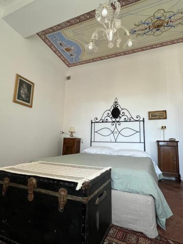 a bedroom with a bed and a chandelier at Apartment Casa Gianfrati in Corfino