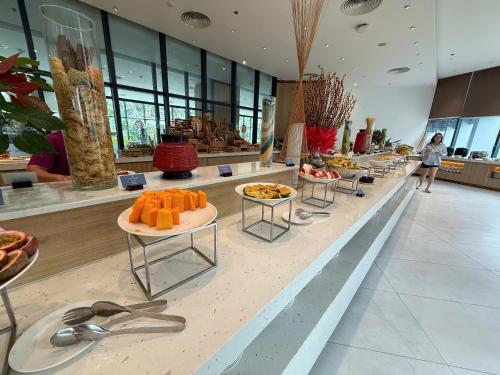 a buffet line with fruit on tables in a building at The Light Arena Ocean Tower in Cam Ranh International Airport