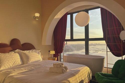 a bedroom with a bed and a large window at Dooga Ins-Retro Opera Deco Seaview Bathtub by Doogahome Homestay in Johor Bahru