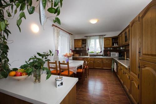 a kitchen with a table and a dining room at Penzion Domanín in Třeboň