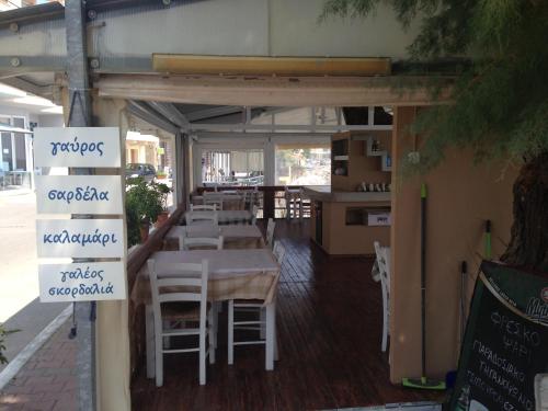 a restaurant with a table and chairs on a patio at Hotel Pelagos Studios in Platána