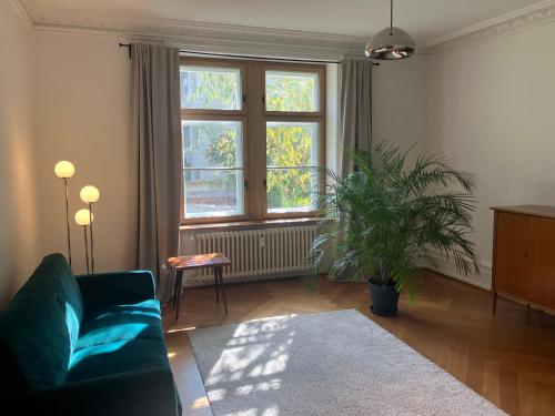 a living room with a couch and a window at Free Parking & Travel Card - Early & Self Check-in in Basel