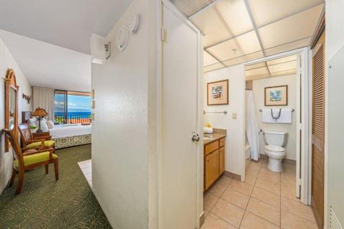 a bathroom with a toilet and a bedroom at Kaanapali Shores 940 · KS 940 Top Floor Studio w Ocean Views AC in Lahaina