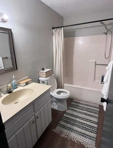 a bathroom with a sink and a toilet and a tub at The Coffee House in Lexington