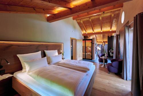 a bedroom with a large bed in a room at ÜbermAlztal Suite in Altenmarkt an der Alz