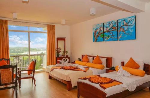 a bedroom with two beds and a large window at Cottage 43 in Nuwara Eliya