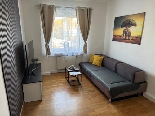 a living room with a couch and a table at Apartment SNOW in Bruck an der Mur