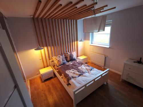 Dwa poziomy Wrocławska في بياويستوك: غرفة نوم بها سرير ونافذة