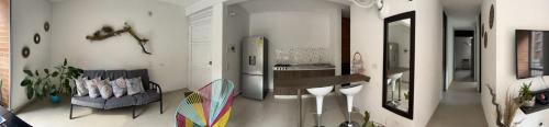 a kitchen with a refrigerator and a table in a room at Apartamento en clima caliente in Apulo
