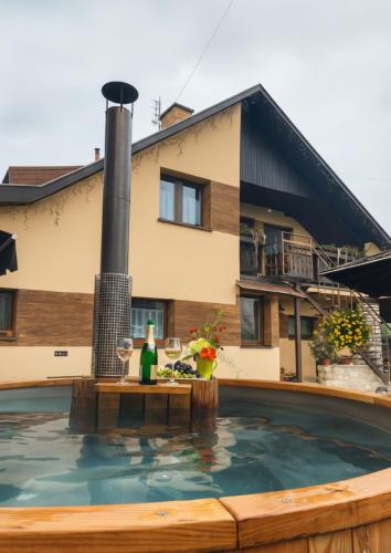 a swimming pool in front of a house at Privát Prima in Liptovský Ján