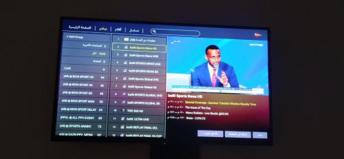 a television screen with a man in a suit at شقة في موقع سياحي لمحبي المناظر الخلابة وشلالات in Beni Mellal