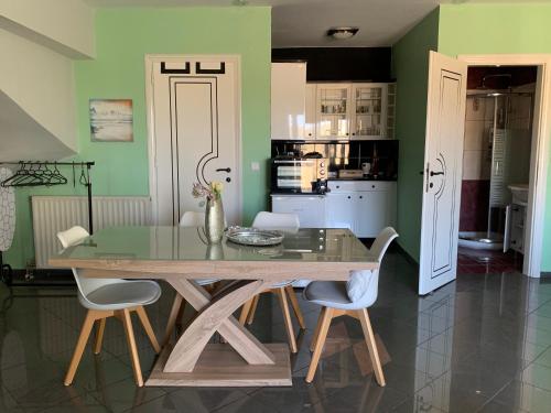 a dining room with a wooden table and chairs at Eden Garden near Knossos in Skalánion
