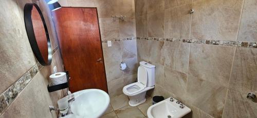 a bathroom with a toilet and a sink at Ribera Calma in Los Reartes