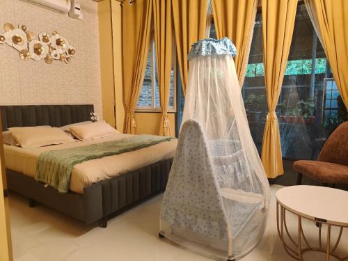 a bedroom with a bed with a net at UDUPI HOMESTAY CHALET LA BONNE Vie in Udupi