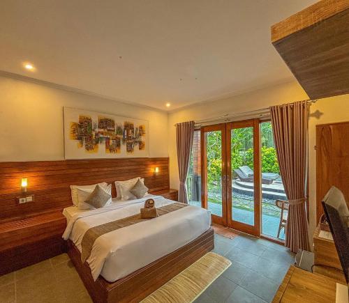 a bedroom with a bed and a large window at Singabu Bungalows in Nusa Penida
