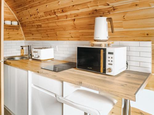 a kitchen with a counter top with a microwave at Islay - Uk48416 in Dalry