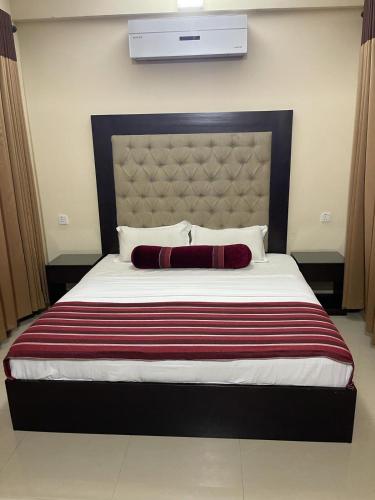 a bedroom with a large bed with a large headboard at Northern Residence in Jaffna