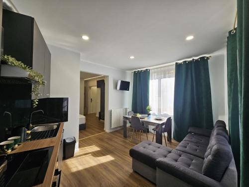 a living room with a couch and a table at Villa Kristin Residence in Monfalcone