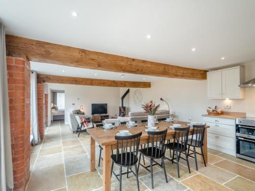 a kitchen and dining room with a wooden table and chairs at The Granary - Uk46002 in Rotsea
