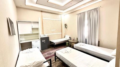 Katil atau katil-katil dalam bilik di Nurbek INN Hotel Tashkent