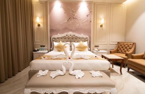 a hotel room with two beds with towels on them at Crown Palazzo in Ludhiana