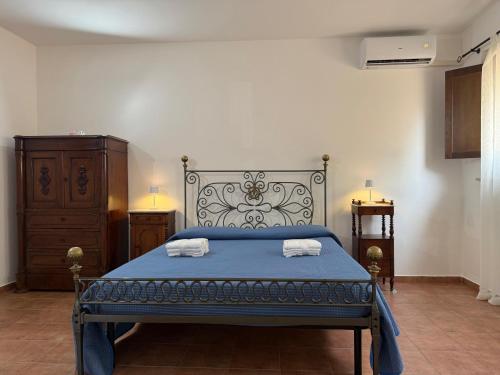 a bedroom with a blue bed with two towels on it at B&B Casa Lydia in Lamezia Terme