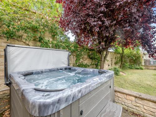 a hot tub in a backyard with a tree at The Glebe in Heckington