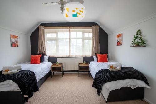 a bedroom with two beds and a window at The Laurels - HS2 Contractors, NEC, BHX, Free Parking in Marston Green
