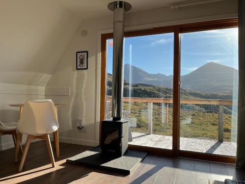 a fireplace in a room with a view of a mountain at Sconser - Uk50491 in Kylestrome