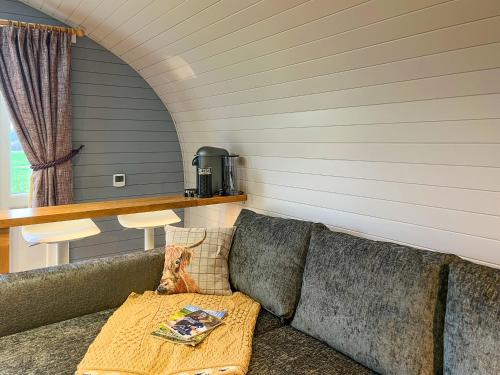 a living room with a couch and a table at Uuu Pod-Uk45325 in Forfar