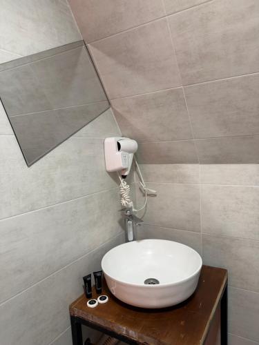 a bathroom with a sink and a hair dryer at Kazbegi Kuro Cottages in Kazbegi