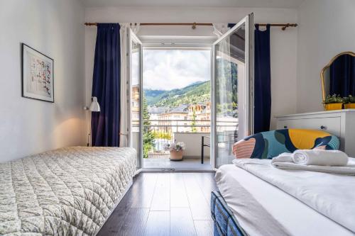 a bedroom with two beds and a large window at Living Eden by we rent in Zell am See
