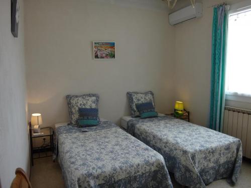 a room with two beds and a window at La campagne in Cuers