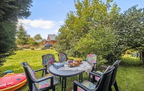 a table and chairs with a teddy bear sitting on it at Ferienwohnung Neuhermsdorf in Neuhermsdorf