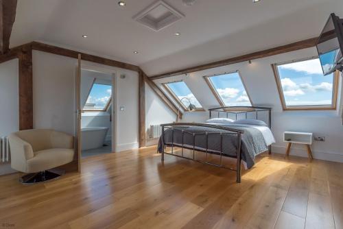 a bedroom with a bed in a room with windows at Bryndeusant in Llanbabo