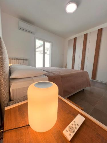 a bedroom with a bed and a table with a remote control at Casa Dea in Paterno