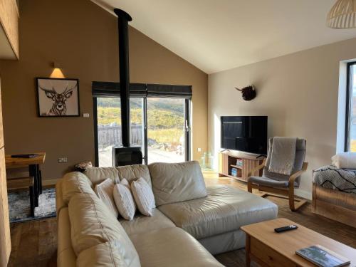 a living room with a couch and a tv at White Cairn - Uk50484 in Kylestrome