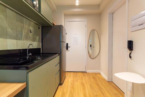 a kitchen with a sink and a white door at CGB302 - Apto com piscina e academia Bela Vista in Sao Paulo